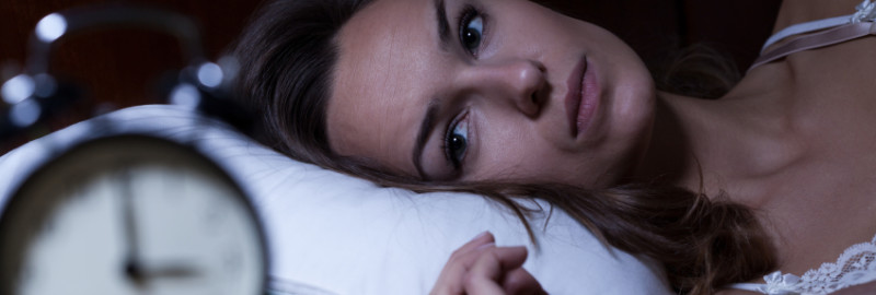 Picture of a woman awake at three o'clock in the morning.